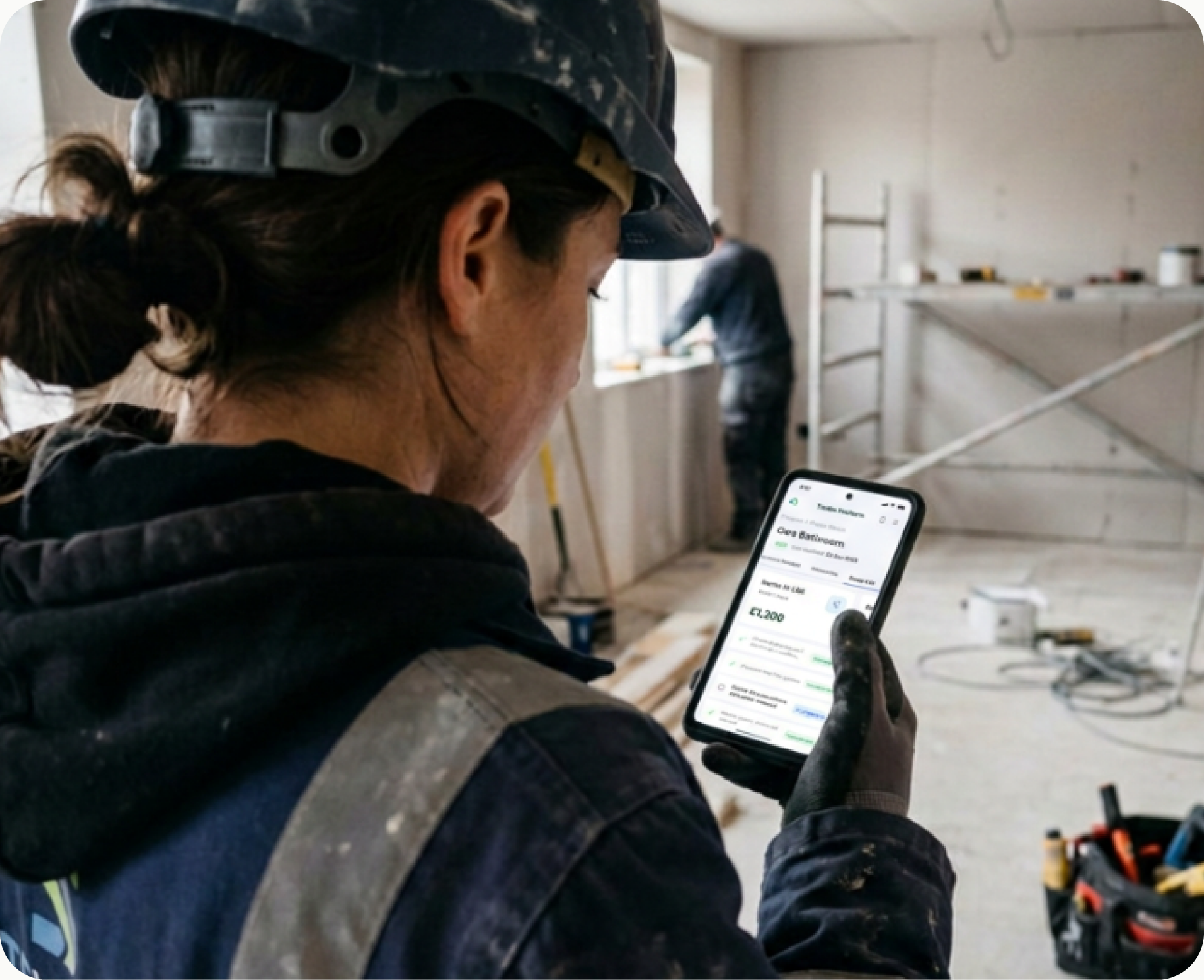 Tradesperson reviewing a project on the Trusted Payments app on site